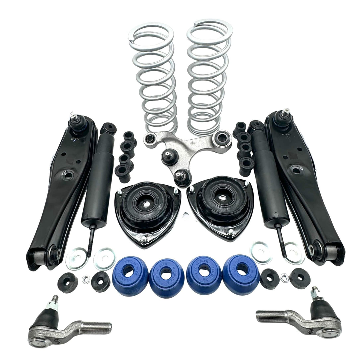 Steering & suspension refresh kit for Honda Acty HA3 HA4 1990-1999 with lowering springs, control arms, shocks, upper mounts, blue polyurethane bushings, washers, and tie rod ends laid out on white background