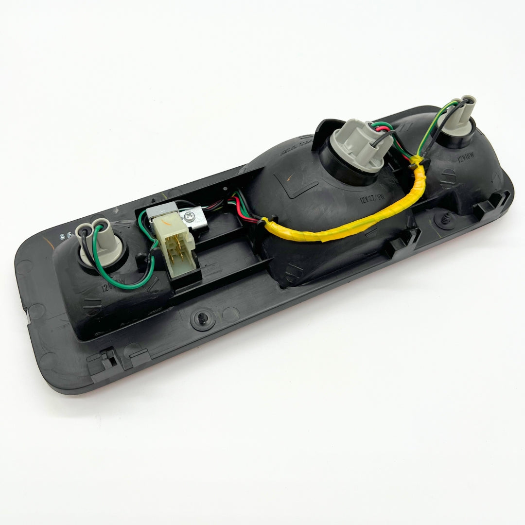 Back view of full tail light assembly kit for left side of Honda Acty Truck HA3, HA4 models (1990-1999) - includes wiring and connectors