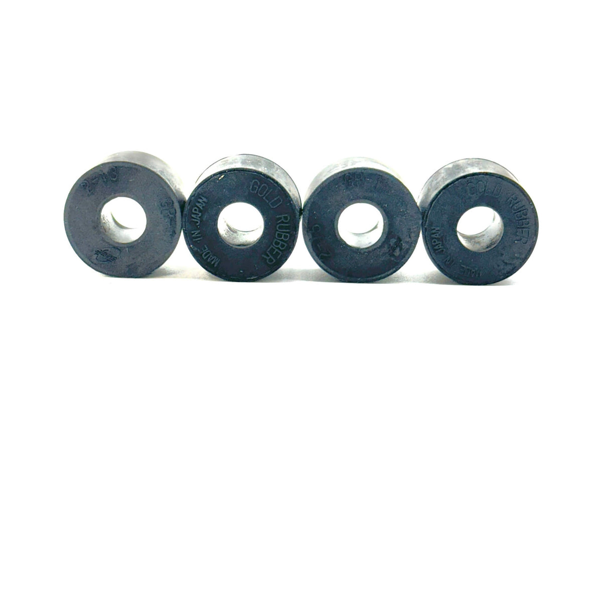 Close-up view of four black Rear Shock Absorber Grommets, made of high-quality rubber for Honda Acty HH3 and HH4 models (1990-1999).