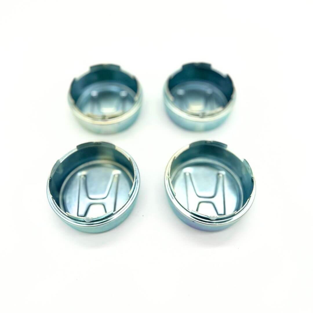 Honda Acty Van Wheel Center Cap Set: Polished metal caps for HH3 and HH4 models, offering a snug fit to protect wheels, enhance aesthetics, and showcase Honda's 'H' logo for easy identification.