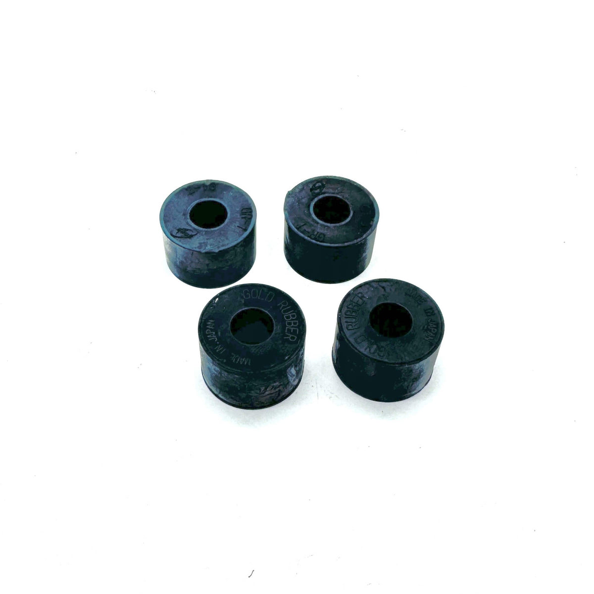 Four Rear Shock Absorber Grommets displayed at an angle, showcasing premium rubber construction for Honda Acty HH3 and HH4 (1990-1999).
