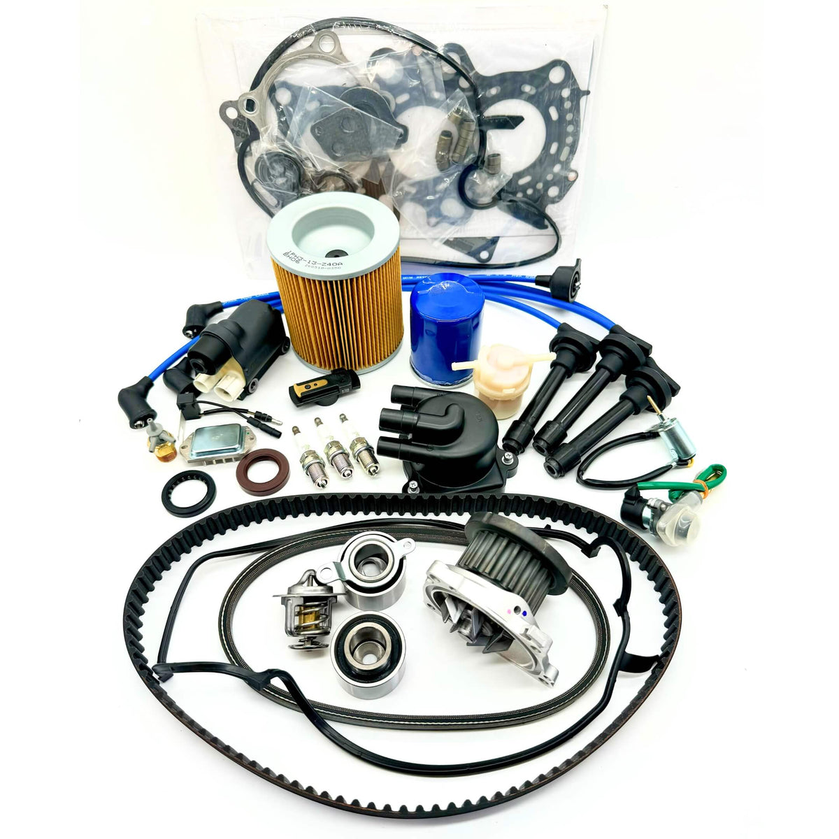 23-piece Mega Timing Belt and Tune-Up Kit for 1990-1999 Honda Acty HH3/HH4 showcased on a white background, including high-quality air and fuel filters, oil filter, distributor cap and rotor, spark plugs with wires, ignition control module with coil sensor, ignition assembly, complete engine gasket set, timing and alternator belts, and air thermal valve, available at Oiwa Garage with free shipping, ideal for vehicle maintenance and engine optimization.