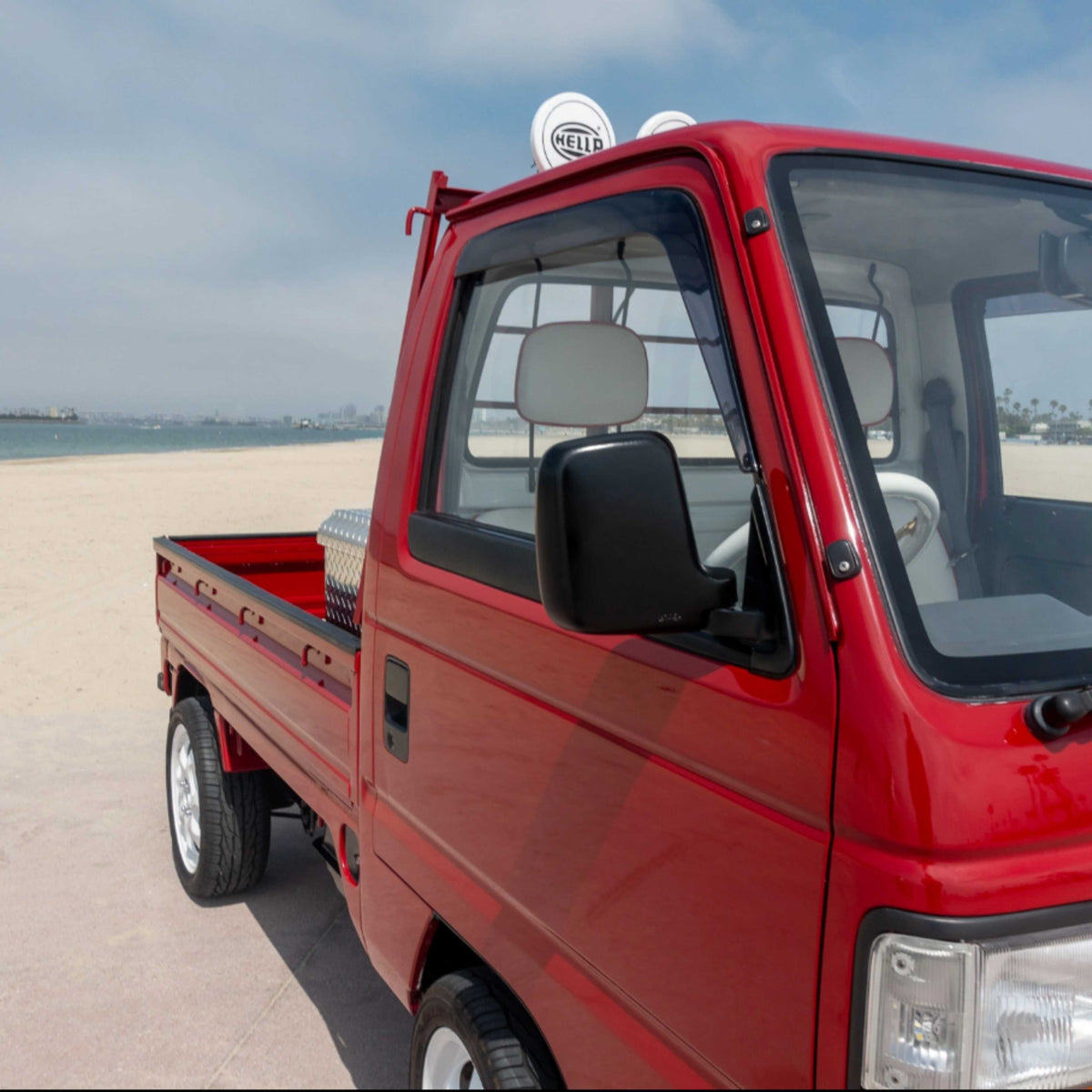 Installed rain guards on Honda Acty Van red model, enhancing ventilation and rain protection